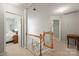 Carpeted hallway with wood railing and views into two bedrooms at 171 Highland Woods Ct, Denver, NC 28037