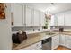 Kitchen with white cabinets, laminate countertops, stainless steel dishwasher, and hardwood floors at 171 Highland Woods Ct, Denver, NC 28037
