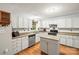 Bright kitchen featuring white cabinets, stainless steel appliances, and a functional center island at 171 Highland Woods Ct, Denver, NC 28037