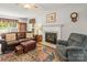 Cozy living room with a fireplace, plush seating, and a colorful area rug creating a warm ambiance at 171 Highland Woods Ct, Denver, NC 28037