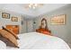 Bright main bedroom features a large bed, tray ceilings, and a classic wooden dresser with a mirror at 171 Highland Woods Ct, Denver, NC 28037