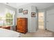 Comfortable main bedroom with neutral walls, wood dresser, and access to an ensuite bathroom at 171 Highland Woods Ct, Denver, NC 28037