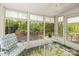 Bright sunroom with views of the wooded backyard and access to the outdoor patio at 171 Highland Woods Ct, Denver, NC 28037