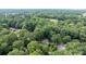 Aerial view of a neighborhood and lush forest with a home nestled in the trees at 1748 4Th Street Ne Ct, Hickory, NC 28601