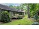 Backyard view featuring a cozy deck, mature trees, and a well-maintained lawn, ideal for outdoor living at 1748 4Th Street Ne Ct, Hickory, NC 28601