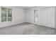 Bright bedroom with neutral carpet, two windows and double closets at 1748 4Th Street Ne Ct, Hickory, NC 28601