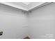 Simple walk-in closet provides ample storage space with metal rack at 1748 4Th Street Ne Ct, Hickory, NC 28601