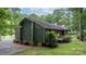 Side view of a charming home with a small wooden deck and lush surrounding greenery at 1748 4Th Street Ne Ct, Hickory, NC 28601