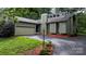 Inviting exterior of a two-story home featuring an attached garage, chimney, and well-maintained landscaping at 1748 4Th Street Ne Ct, Hickory, NC 28601