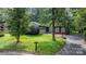Charming home with lush front yard, a black asphalt driveway, and attached garage, perfect for suburban living at 1748 4Th Street Ne Ct, Hickory, NC 28601