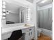Well-lit vanity and bath featuring Hollywood lighting providing an abundance of light at 1748 4Th Street Ne Ct, Hickory, NC 28601
