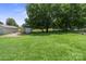 Expansive backyard with lush green grass, mature trees, and a storage shed, offering a serene outdoor space at 1787 Eastover Dr, Mount Pleasant, NC 28124
