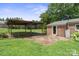Spacious backyard featuring a covered patio and a brick building extension with a door at 1787 Eastover Dr, Mount Pleasant, NC 28124
