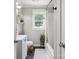 Well-lit bathroom featuring a window, classic tub and vanity with a clean and functional design at 1787 Eastover Dr, Mount Pleasant, NC 28124