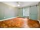 Bright bedroom with a window seat, custom sliding shutters and wood flooring at 1787 Eastover Dr, Mount Pleasant, NC 28124
