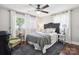 Comfortable bedroom with windows on two sides and a ceiling fan and an area rug adding to its charm at 1787 Eastover Dr, Mount Pleasant, NC 28124