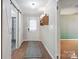Inviting entryway featuring wood floors, white wainscoting, and a decorative sliding barn door at 1787 Eastover Dr, Mount Pleasant, NC 28124