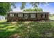 Charming brick home featuring black shutters and a well-maintained lawn at 1787 Eastover Dr, Mount Pleasant, NC 28124