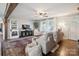 Comfortable living room with hardwood floors, ceiling fan, and large windows providing natural light at 1787 Eastover Dr, Mount Pleasant, NC 28124