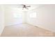 Bright bedroom with neutral carpet, two windows, and a ceiling fan at 1810 Highway 55 W Hwy, Clover, SC 29710