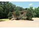 The stone house features well-maintained landscaping, mature trees, and a manicured front yard at 1810 Highway 55 W Hwy, Clover, SC 29710