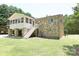 Exterior view of the stone home with a screened in porch and stairs leading to the backyard at 1810 Highway 55 W Hwy, Clover, SC 29710