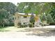 A beautiful stone home surrounded by mature trees and a well-manicured lawn at 1810 Highway 55 W Hwy, Clover, SC 29710