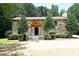 The facade of a stone house with a manicured lawn and mature trees framing the entrance at 1810 Highway 55 W Hwy, Clover, SC 29710
