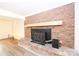 Living room fireplace features a brick surround and hearth, with a wood-burning stove insert at 1810 Highway 55 W Hwy, Clover, SC 29710