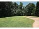 Expansive front yard with a lush lawn, mature trees, and a paved driveway at 1810 Highway 55 W Hwy, Clover, SC 29710