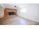 Basement living area with brick fireplace and a hardwood floor at 1810 Highway 55 W Hwy, Clover, SC 29710
