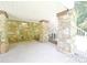 Covered outdoor patio with stone pillars and access to stairs leading to the upper level at 1810 Highway 55 W Hwy, Clover, SC 29710