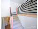 Carpeted stairs with modern railing lead to the upper level, offering a stylish transition between floors at 1810 Highway 55 W Hwy, Clover, SC 29710