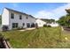 View of the large backyard, featuring a green lawn, white fencing and convenient storage shed at 1901 Summit Ridge Ln, Kannapolis, NC 28083