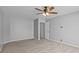 This bedroom features gray walls, tan carpet, ceiling fan with lights, and an open door at 1901 Summit Ridge Ln, Kannapolis, NC 28083