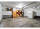 Spacious garage with storage cabinets, shelving, and a utility sink, offering ample space for vehicles and projects at 1901 Summit Ridge Ln, Kannapolis, NC 28083