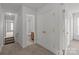 This hallway leads to a bedroom, bathroom, and closet with paneled doors and carpeted floors at 1901 Summit Ridge Ln, Kannapolis, NC 28083