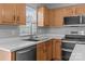 Kitchen featuring stainless steel appliances, wood cabinets, a sink, and a window for natural light at 1901 Summit Ridge Ln, Kannapolis, NC 28083