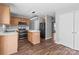 Open kitchen with modern appliances, island with white countertop, and hardwood flooring at 1901 Summit Ridge Ln, Kannapolis, NC 28083