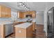 Modern kitchen with wood cabinets, stainless steel appliances, and a central island at 1901 Summit Ridge Ln, Kannapolis, NC 28083