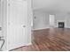 Open living area with a doorway, hardwood floors, a light gray color scheme, and a fireplace at 1901 Summit Ridge Ln, Kannapolis, NC 28083