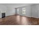 Bright living room with a fireplace, hardwood floors, and large windows that provide natural light at 1901 Summit Ridge Ln, Kannapolis, NC 28083
