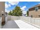 The back deck is freshly painted with a white fence overlooking the large shady yard at 2005 Amos Oaks Ln, Charlotte, NC 28215