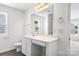 Bright bathroom features a large mirror, vanity with storage, and modern fixtures at 2005 Amos Oaks Ln, Charlotte, NC 28215