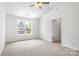 Bedroom with vaulted ceiling, ceiling fan and a bright window offering natural light at 2005 Amos Oaks Ln, Charlotte, NC 28215