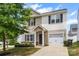 Two-story home with beige siding, black shutters, and a well-manicured front yard at 2005 Amos Oaks Ln, Charlotte, NC 28215