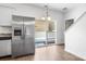 Bright kitchen features stainless steel refrigerator and access to outdoor deck through sliding glass door at 2005 Amos Oaks Ln, Charlotte, NC 28215