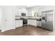Modern kitchen featuring stainless steel appliances, granite countertops, and white cabinets at 2005 Amos Oaks Ln, Charlotte, NC 28215