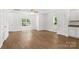 Bright living room featuring wood floors and white walls, flooded with natural light at 2005 Amos Oaks Ln, Charlotte, NC 28215