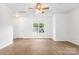 Open living space featuring wood floors, white walls, and a modern ceiling fan at 2005 Amos Oaks Ln, Charlotte, NC 28215